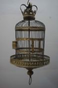 Unusual birdcage in brass and wrought iron, richly decorated bottom and feeding bowls and a crown at