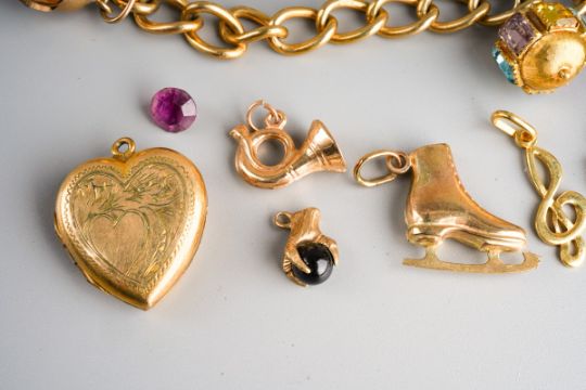 A charm bracelet, the 9ct gold curb link bracelet suspending several charms, to include 9ct and - Image 2 of 3