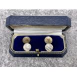 Pair of early 20th century gold and white enamel round twin-panel cufflinks. With chain inter-links,