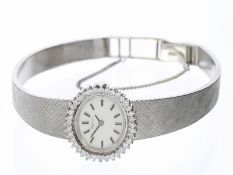 Armbanduhr: schöne, weißgoldene vintage Schmuckuhr mit Diamantbesatz, 18K Gold