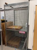 Security cage with two shelves.