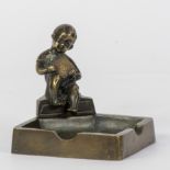 Geo VINDEVOGEL (1923-1977), bronze sculpture of a young boy mounted on a bronze ashtray carrying a b