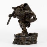 Very finely sculpted bronze statue of a walking man with mantle cap and 2 baskets serving as holders