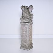 Decorative stone garden ornament of a stone mythical creature sitting on a plinth with a beautiful w
