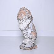 Stone garden statue in the shape of a lion with a weathered patina