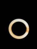 A WHITE AND RUSSETT JADE BANGLE, China, 19th / 20th century