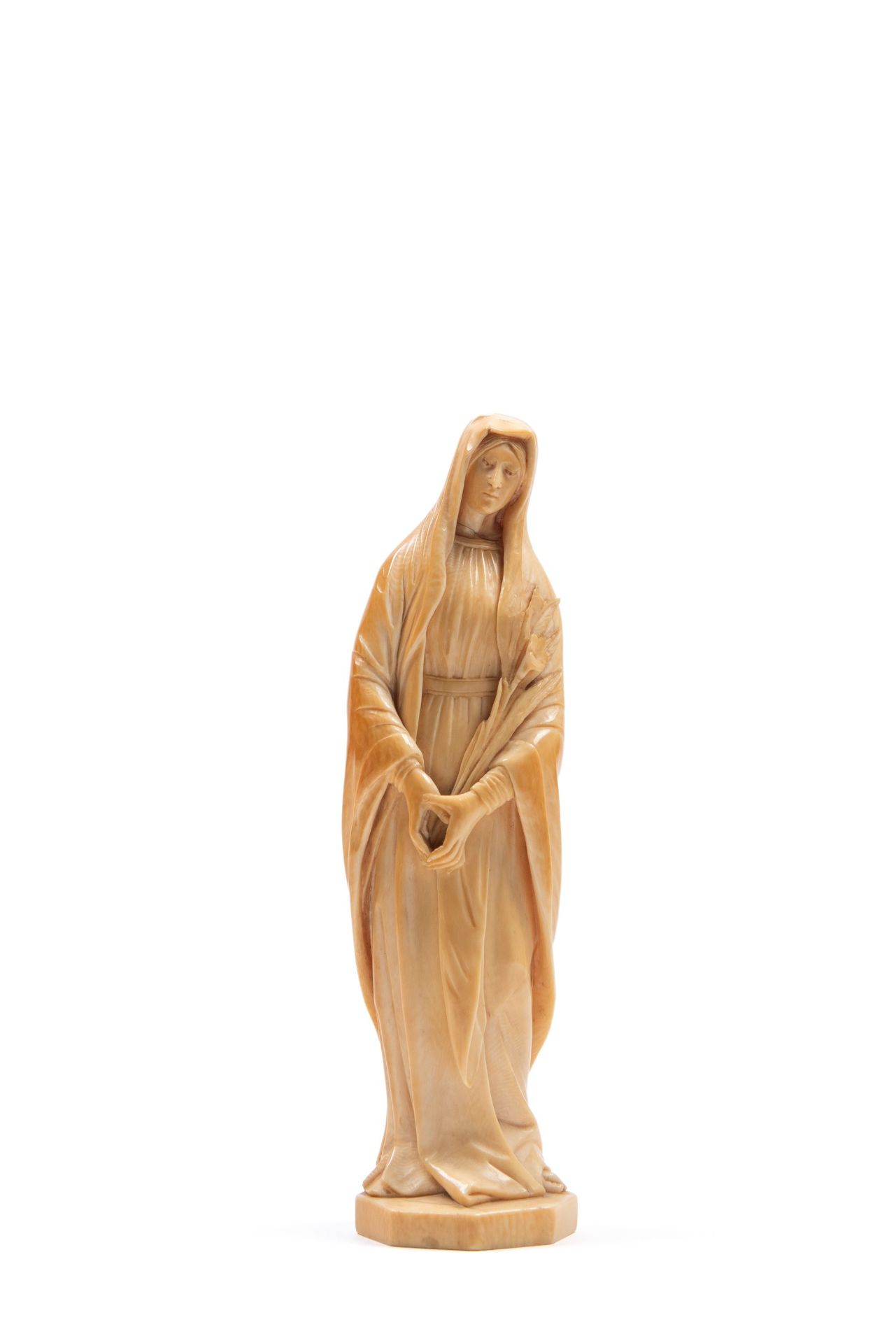â˜¼IVORY SCULPTURE DEPICTING A SAINT WITH A LILY, 19th century