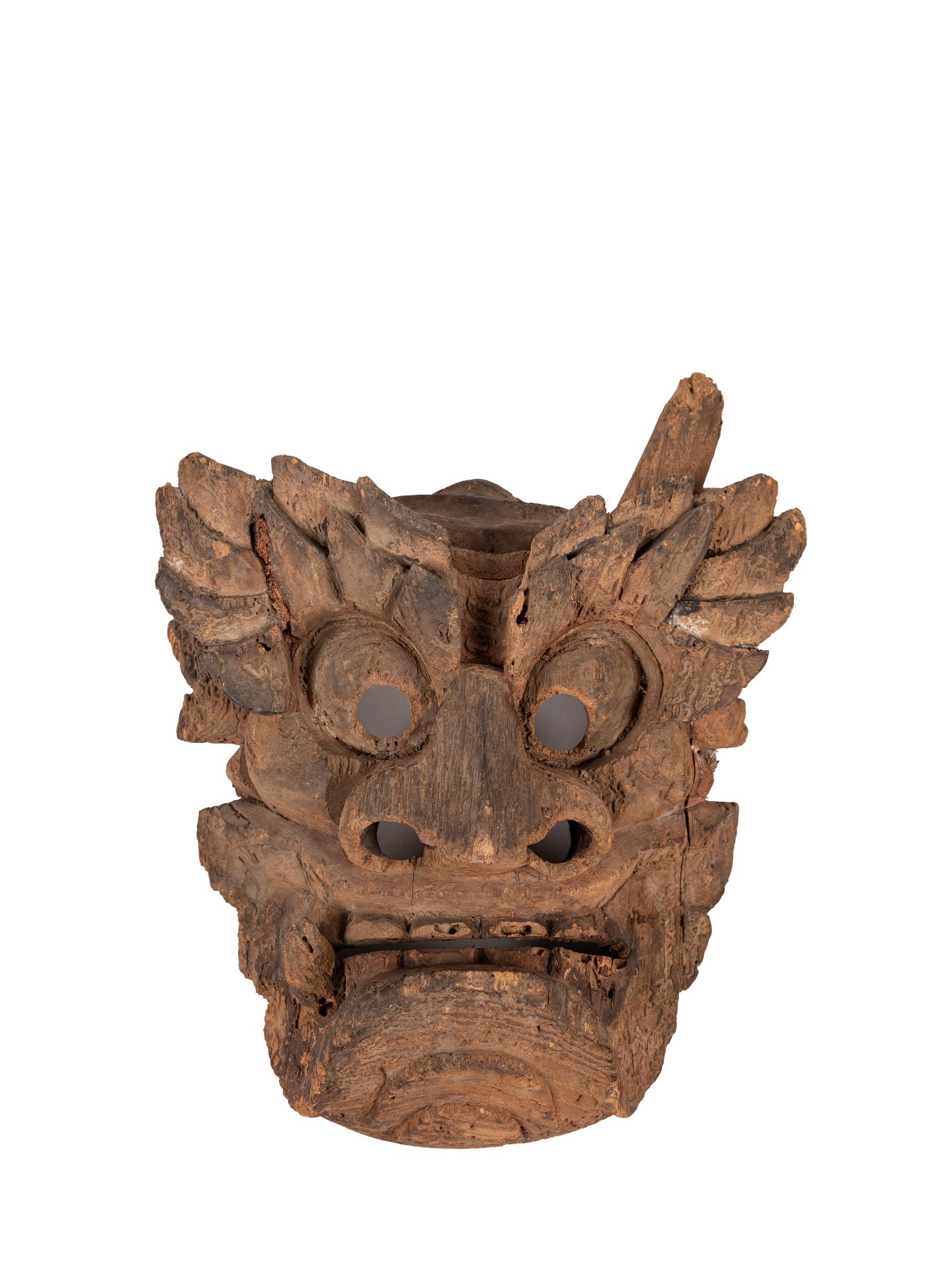 AN ANCIENT ORIENTAL WOODEN MASK DEPICTING A DEMON,