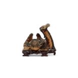 â˜¼IVORY SCULPTURE DEPICTING A CROUCHING CAMEL ON A WOODEN BASE, China, early 20th century