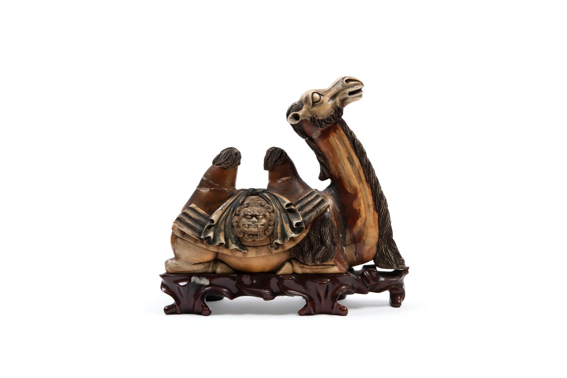 â˜¼IVORY SCULPTURE DEPICTING A CROUCHING CAMEL ON A WOODEN BASE, China, early 20th century