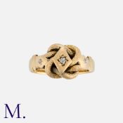 An Antique Lovers Knot Ring in 18 carat yellow gold, the knotted form set with a central old cut