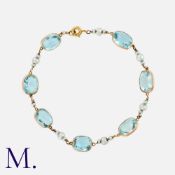 An Aquamarine And Pearl Bracelet in yellow gold, comprising a series of seven spectacle-set