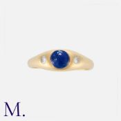 A Sapphire And Diamond Gypsy Ring in 18k yellow gold, set with a tall cabochon sapphire between