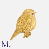 HERMES. A Vintage Bird Brooch in 18K yellow gold with a ruby eye, signed Hermes Paris to the