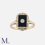 An Onyx and Diamond Ring in yellow gold, with an onyx plaque set with a round cut diamond to the