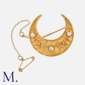 An Antique Diamond-Set Crescent Brooch in yellow gold, with intricate filigree-work, set with