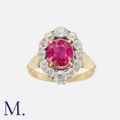 A Fine Burma No Heat Ruby And Diamond Cluster Ring, in yellow gold, set with a principal cushion cut