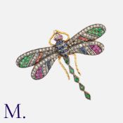 A Gem Set Brooch in yellow gold and silver, designed as a dragon fly, set with tsavorite garnet,