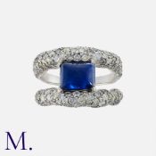 Faberge, A Sapphire And Diamond Ring, in platinum, set with a principal sugarloaf sapphire, the