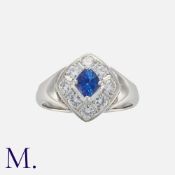 A Sapphire And Diamond Ring in platinum, set with a principal kite shaped sapphire of
