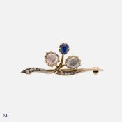 A Rose Cut Diamond And Sapphire Brooch in yellow gold, of foliate design, set with two large rose