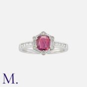 A Ruby And Diamond Cluster Ring in white gold Set with a principal ruby of approximately 0.60ct,