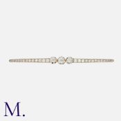 A Diamond Brooch in yellow gold and platinum, set with three principal old cut diamonds, accented