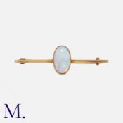 An Antique Opal Bar Brooch in yellow gold set with a cabochon opal measuring 12 x 7mm. Unmarked,