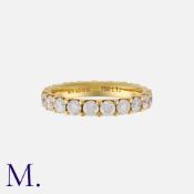 A Diamond Eternity Ring in 18k yellow gold, set throughout with round cut diamonds totalling