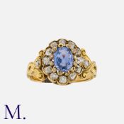 An Antique Sapphire And Diamond Cluster Ring in yellow gold, set with a principal oval cut