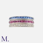 A Reversible Ruby, Sapphire And Diamond Ring in platinum, set all around with a row of calibre cut