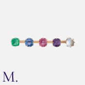 A Gem-Set Bar Brooch in yellow gold, set with an emerald, sapphire, ruby, amethyst and moonstone.