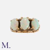 An Opal Three Stone Ring in 9k yellow gold, set with three cabochon opals. Full British Hallmarked