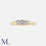 A Diamond Three Stone Ring in 18k yellow gold, bezel set with three round cut diamonds totalling