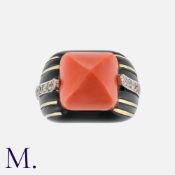 Attributed To DONALD CLAFLIN. A Fine Coral, Diamond And Onyx Ring, set with a large sugarloaf