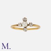 A Pearl And Diamond Ring in yellow gold, set with a central pearl, accented by four old cut