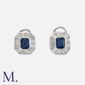 A Pair Of Sapphire And Diamond Earrings in 18k white gold, each comprising an octagonal cut sapphire