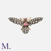 An Antique Diamond And Ruby Insect Brooch in yellow gold and silver, the body set with a cabochon