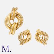 A Diamond Brooch And Earring Suite in 18k yellow gold, comprising a brooch of knotted design, set
