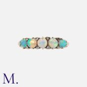 An Opal And Diamond Five Stone Ring in yellow gold, set with a row of five cabochon opals,