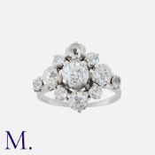 A Diamond Cluster Ring in white gold, set with a principal old cut diamond weighing approx. 0.75ct