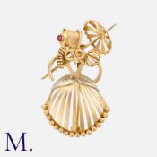 A Retro Brooch in yellow gold, taking the form of lady with a parasol in abstract. Marks unclear;