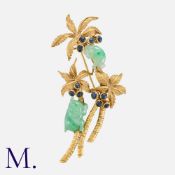 A Jade And Sapphire Brooch in 18k yellow gold, designed as three palm trees, accented by jadeite