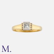 A Diamond Solitaire Ring in 18K yellow and white gold, set with a princess cut diamond weighing 0.