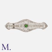 A Green Garnet and Diamond Brooch, in 14 carat white gold, the openwork, geometric brooch set with