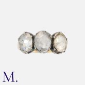 An Antique Rose Cut Diamond Three Stone Ring in yellow gold and silver, set with three large rose