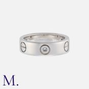 CARTIER, A Classic 3-Diamond Love Ring in 18K white gold set with three diamonds. Signed and