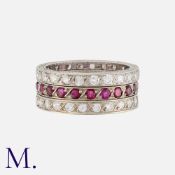 A Set of Three Diamond and Ruby Eternity Rings in platinum, two set with round cut diamonds weighing