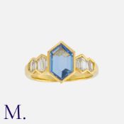 A Sapphire and Diamond Ring in 18 carat yellow gold, set with a hexagonal portrait cut sapphire,