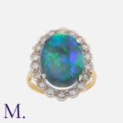 An Opal And Diamond Cluster Ring in 18 carat yellow gold and platinum, set with a large cabochon